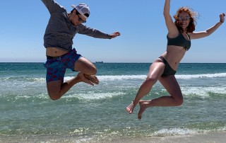 two people jumping on Alabama beach