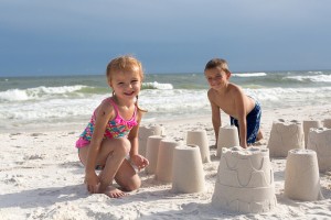 children building sandcastles on the beach
